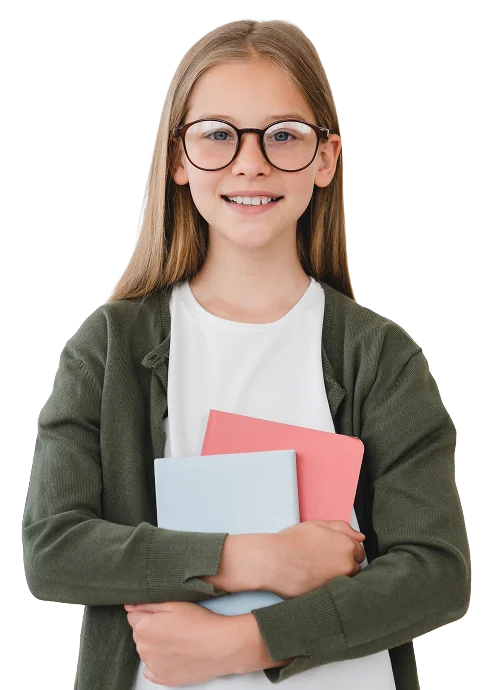 A young girl with long hair and glasses is smiling and holding two notebooks, one pink and one blue, against her chest. She is wearing a white shirt and a green cardigan.